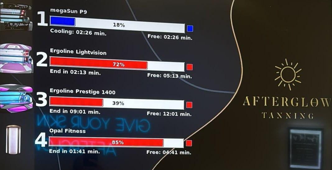 Afterglow Tanning in-studio availability board showing live status of all four sunbeds